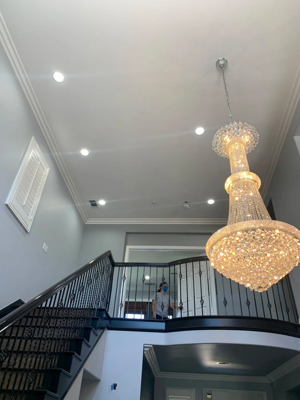 Chandelier and recessed lighting installed in a two-story home